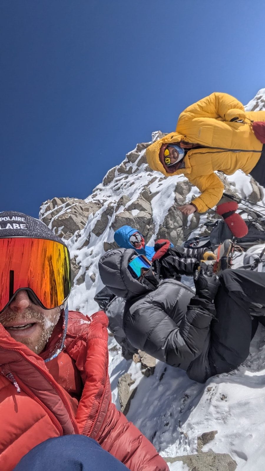 Sam high on Aconcagua, beard iced over, deep blue high-altitude sky behind